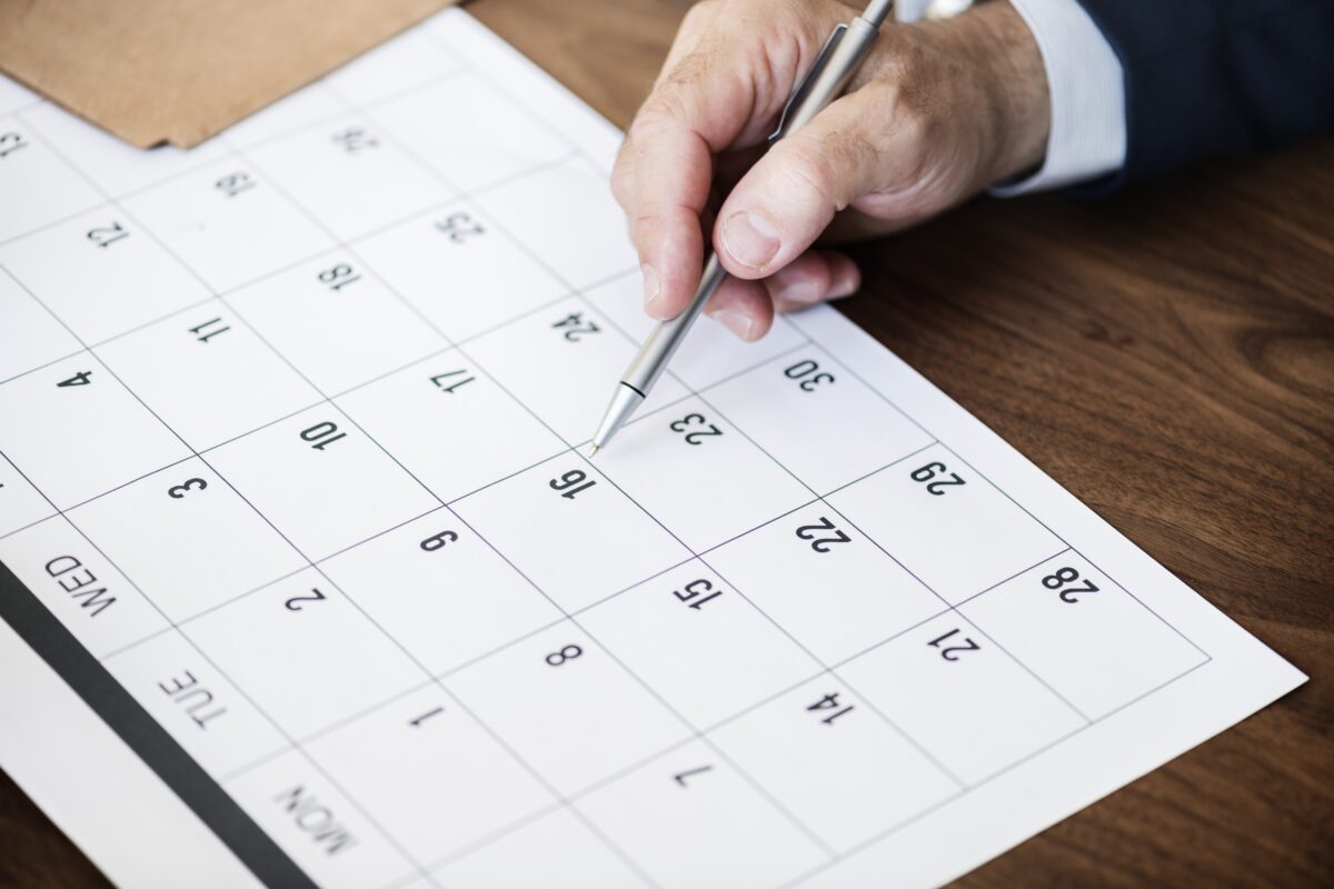 businessman-marking-on-calendar-for-an-appointment-min