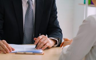 Job seeker in job interview meeting with manager and interviewer at corporate office. The young interviewee seeking for a professional career job